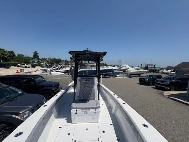 Slide: The Image of 2025 Latitude Tournament Boats 25 at marina, surrounded by parked vehicles and other boats. - 10