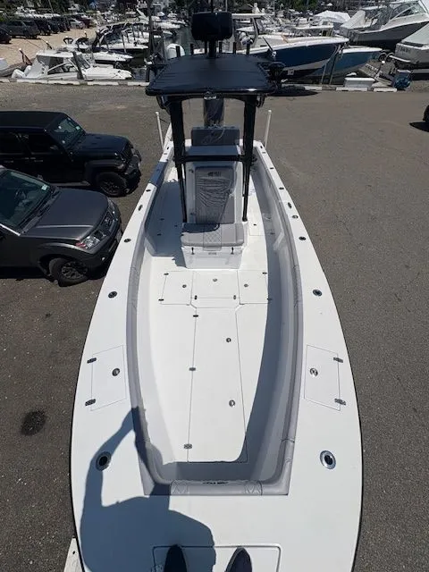 Slide: The Image of 2025 Latitude Tournament Boats 25, sleek design, docked with vehicles nearby. - 11