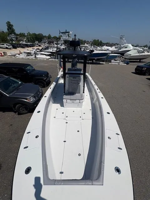 Slide: The Image of 2025 Latitude Tournament Boats 25, sleek design, docked among other boats in a marina. - 12