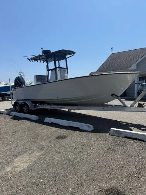 Slide: The Image of 2025 Latitude Tournament Boats 25 on trailer, parked outdoors under clear blue sky. - 3