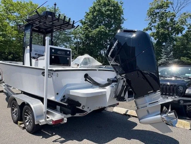 Slide: The Image of 2025 Latitude Tournament Boats 25 on trailer, featuring powerful Mercury outboard engine. - 4