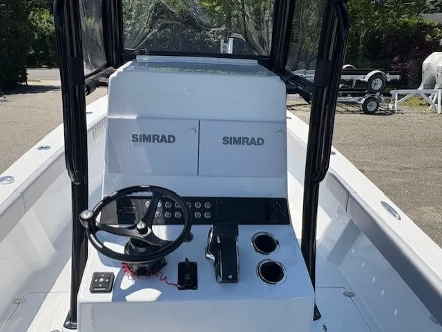 Slide: The Image of 2025 Latitude Tournament Boats 25 console with Simrad electronics and steering wheel. - 6