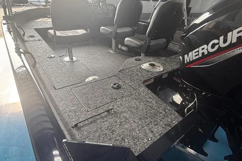 Slide: The Image of 2026 Tracker PG V16 SC boat interior with Mercury engine, featuring seating and carpeted deck. - 4