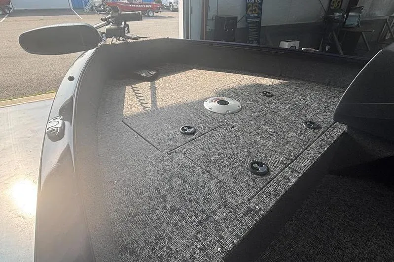 Slide: The Image of 2026 Tracker PG V16 SC boat interior with carpeted deck and storage compartments. - 7