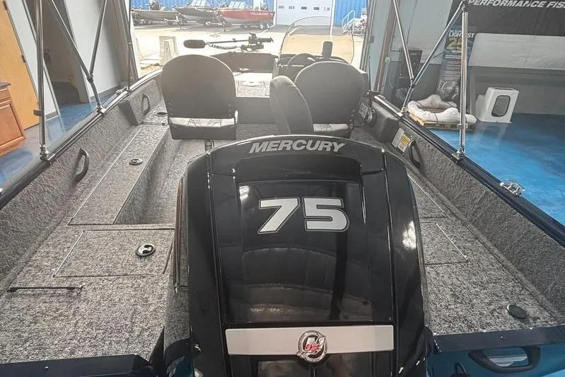 Slide: The Image of 2026 Tracker PG V16 SC boat interior with Mercury 75 engine, featuring seating and storage. - 8