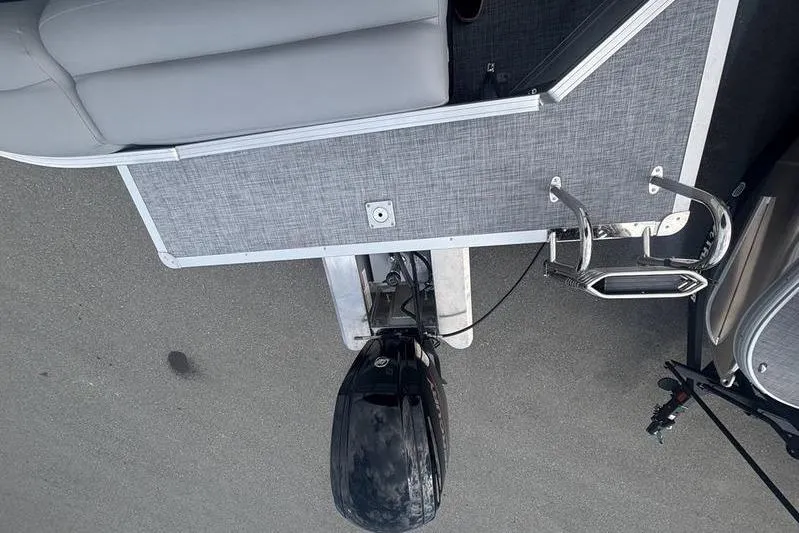 Slide: The Image of 2026 Sun Tracker PB 20 DLX pontoon boat with motor and ladder, viewed from above. - 11