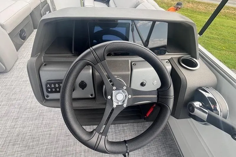 Slide: The Image of Steering console of 2026 Sun Tracker PB 20 DLX pontoon boat with modern controls. - 8