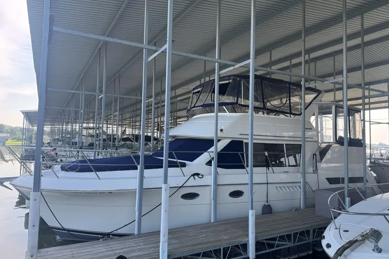 Slide: The Image of 1998 Carver 405 Motor Yacht docked in a covered marina. - 0