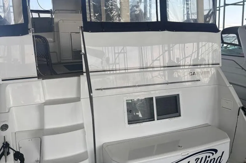 Slide: The Image of 1998 Carver 405 Motor Yacht with white exterior and covered deck area. - 11