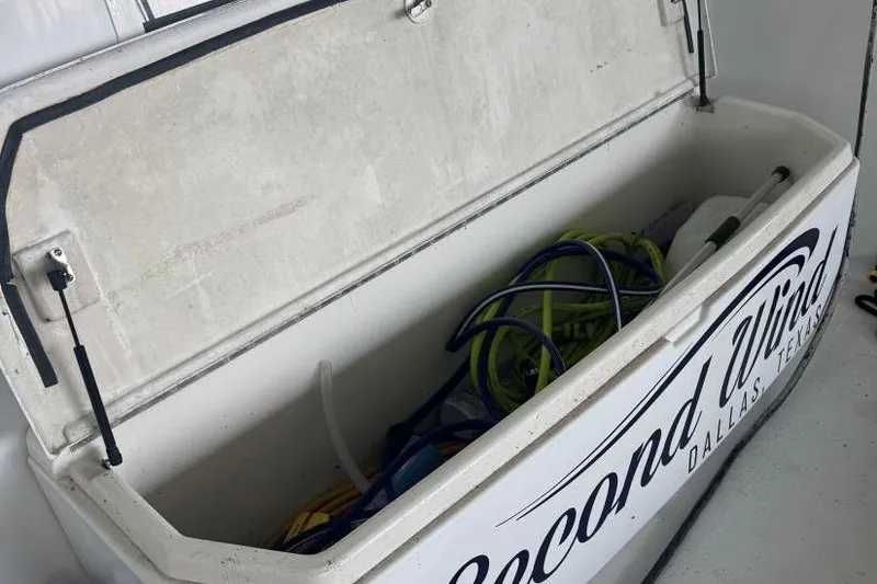 Slide: The Image of Open storage compartment on Carver 405 Motor Yacht, 1998, with hoses and equipment inside. - 12