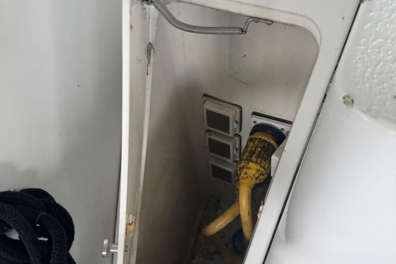 Slide: The Image of Electrical compartment of 1998 Carver 405 Motor Yacht with yellow power cable. - 13