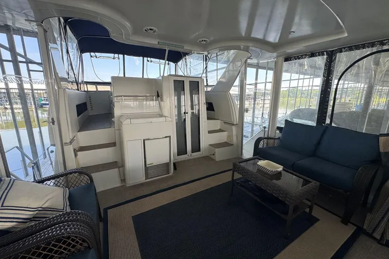 Slide: The Image of 1998 Carver 405 Motor Yacht interior with seating area and steps to upper deck. - 14