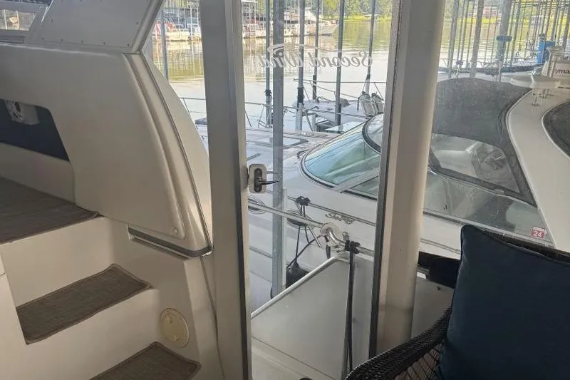 Slide: The Image of 1998 Carver 405 Motor Yacht interior view with marina backdrop. - 17