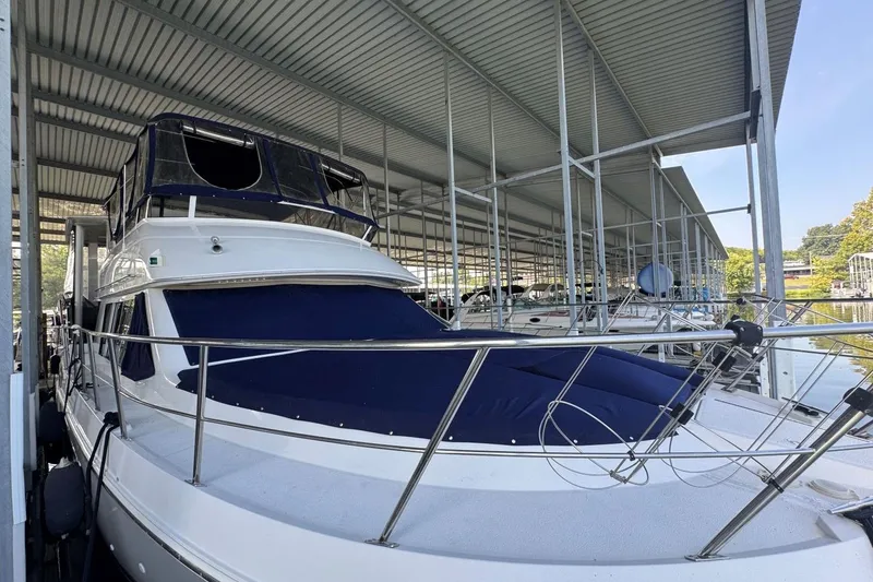 Slide: The Image of 1998 Carver 405 Motor Yacht docked under a covered marina. - 2