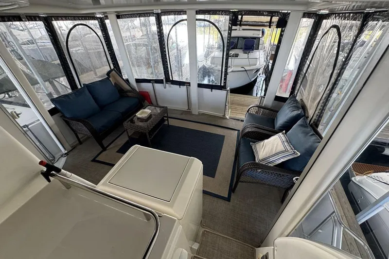 Slide: The Image of 1998 Carver 405 Motor Yacht interior with cozy seating and panoramic windows. - 20