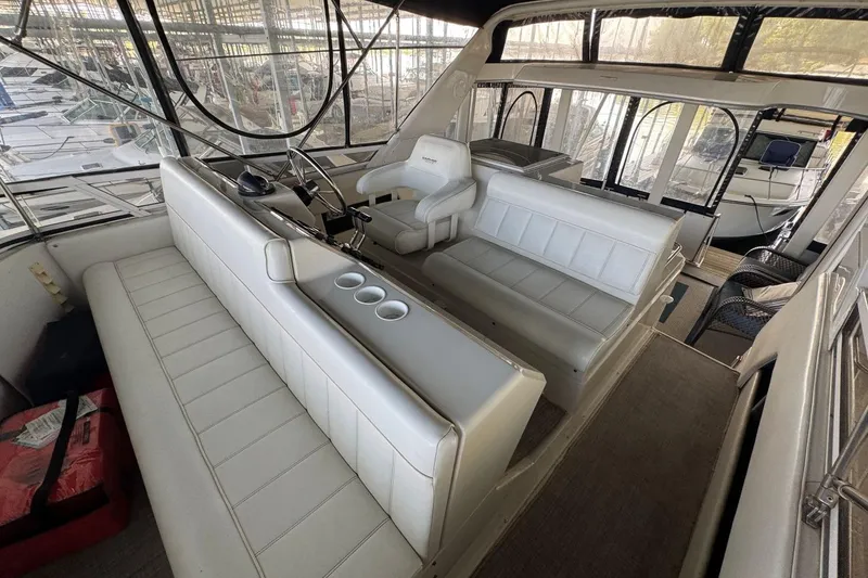 Slide: The Image of Interior of a 1998 Carver 405 Motor Yacht with white seating and helm station. - 22