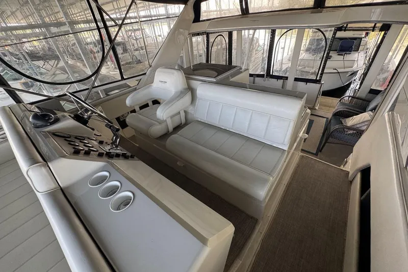 Slide: The Image of 1998 Carver 405 Motor Yacht interior with helm, seating, and panoramic windows. - 23