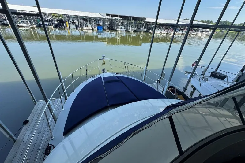 Slide: The Image of 1998 Carver 405 Motor Yacht docked in a marina, view from the deck. - 25