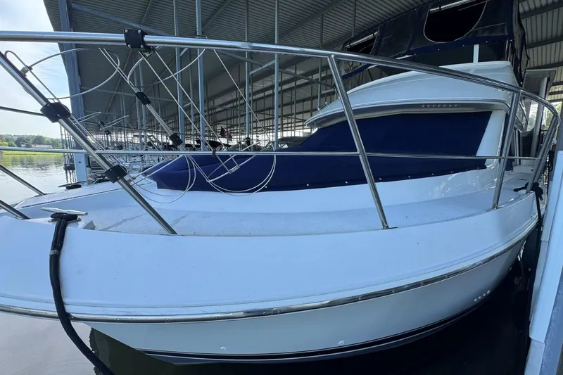 Slide: The Image of 1998 Carver 405 Motor Yacht docked under a covered marina. - 3