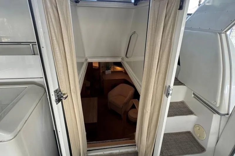 Slide: The Image of Interior view of 1998 Carver 405 Motor Yacht, showing stairs and cozy seating area. - 30