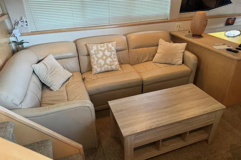 Slide: The Image of Interior of 1998 Carver 405 Motor Yacht with beige leather sofa and wooden table. - 33