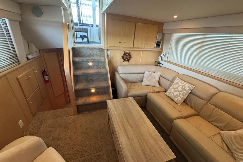 Slide: The Image of Interior of 1998 Carver 405 Motor Yacht with cozy seating and wooden accents. - 36