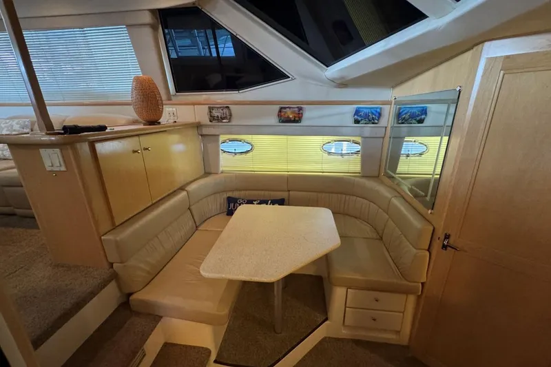 Slide: The Image of Interior of 1998 Carver 405 Motor Yacht with cozy dining area and beige seating. - 39