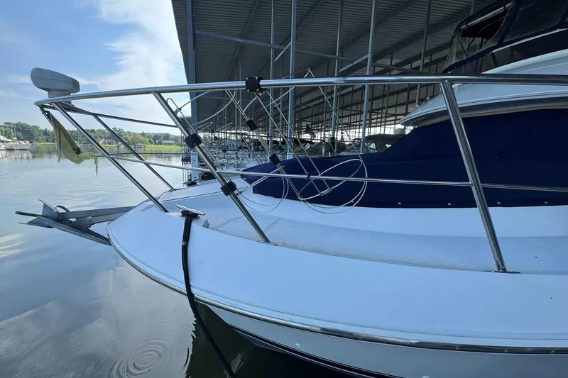 Slide: The Image of 1998 Carver 405 Motor Yacht docked, featuring sleek design and stainless steel railings. - 4