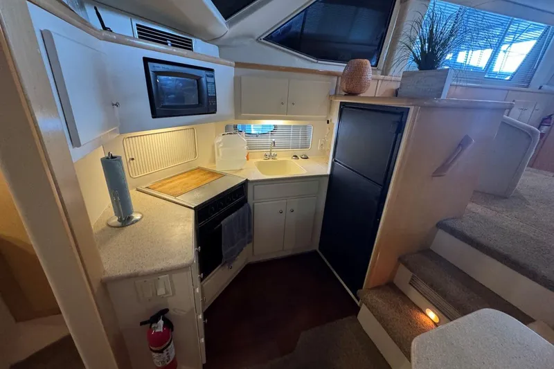 Slide: The Image of Compact kitchen area in a 1998 Carver 405 Motor Yacht with modern amenities. - 40