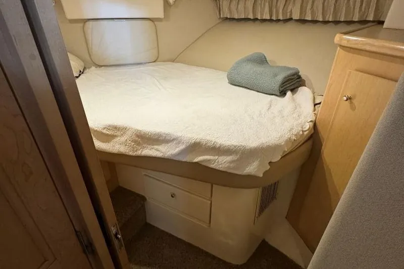 Slide: The Image of Cozy bedroom in 1998 Carver 405 Motor Yacht with neatly made bed and folded towel. - 43