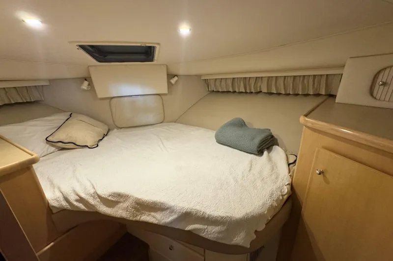 Slide: The Image of Cozy bedroom in 1998 Carver 405 Motor Yacht with bed, pillows, and soft lighting. - 44