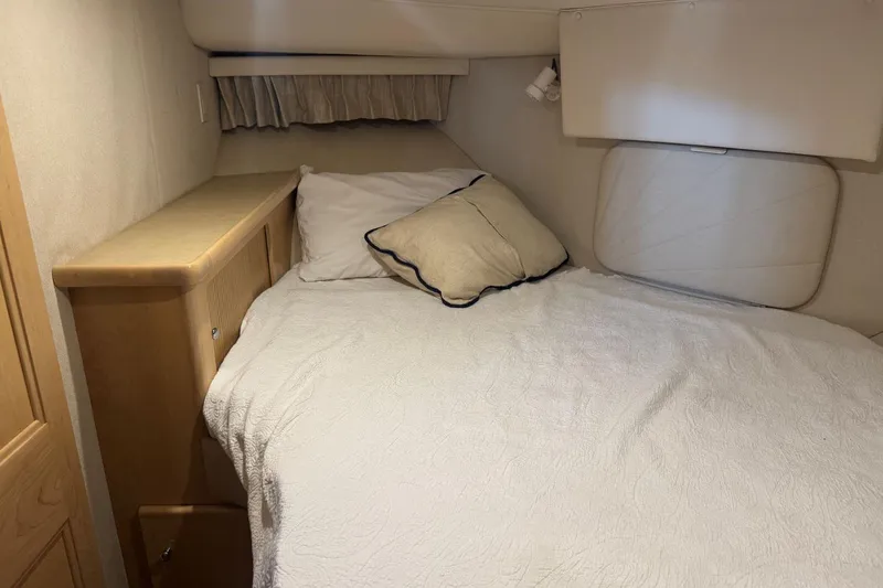 Slide: The Image of Cozy bedroom in 1998 Carver 405 Motor Yacht with white bedding and wooden accents. - 46