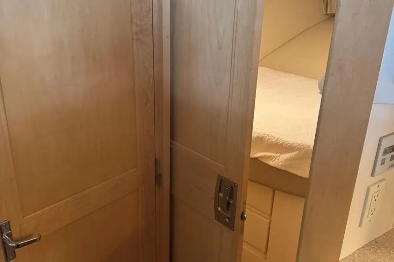 Slide: The Image of Interior cabin view of 1998 Carver 405 Motor Yacht with wooden doors and cozy bed. - 47