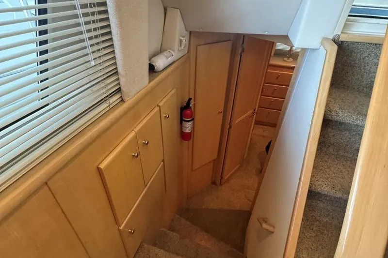 Slide: The Image of Interior of 1998 Carver 405 Motor Yacht with stairs, cabinets, and fire extinguisher. - 49