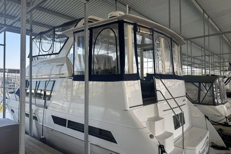 Slide: The Image of 1998 Carver 405 Motor Yacht docked in a covered marina. - 5
