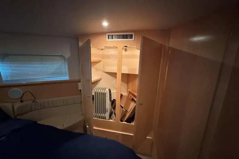 Slide: The Image of Interior of 1998 Carver 405 Motor Yacht with open closet and heater. - 52