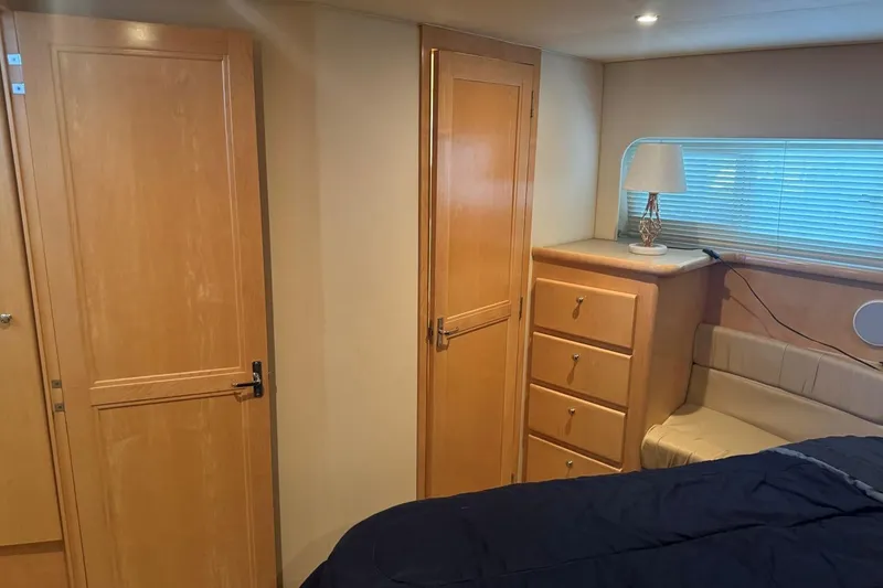 Slide: The Image of Interior of 1998 Carver 405 Motor Yacht with wooden cabinetry and cozy seating area. - 53