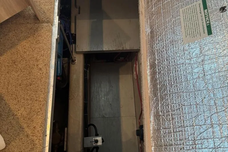 Slide: The Image of Engine compartment of a 1998 Carver 405 Motor Yacht, featuring insulation and wiring. - 56