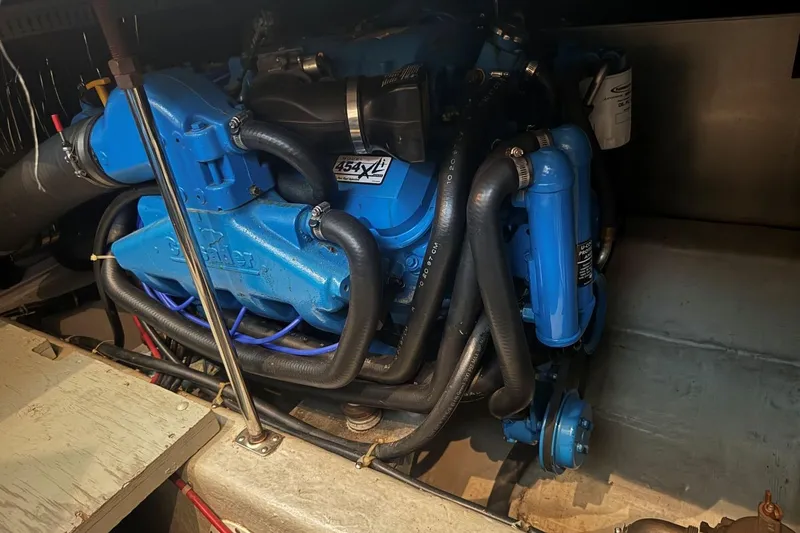 Slide: The Image of Engine of a 1998 Carver 405 Motor Yacht, featuring blue components and hoses. - 57