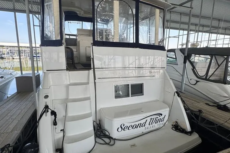 Slide: The Image of 1998 Carver 405 Motor Yacht docked, featuring "Second Wind" name, Dallas, Texas. - 6