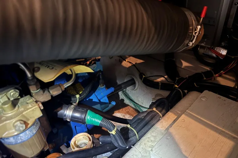 Slide: The Image of Engine room of a 1998 Carver 405 Motor Yacht, showing hoses and wiring. - 60