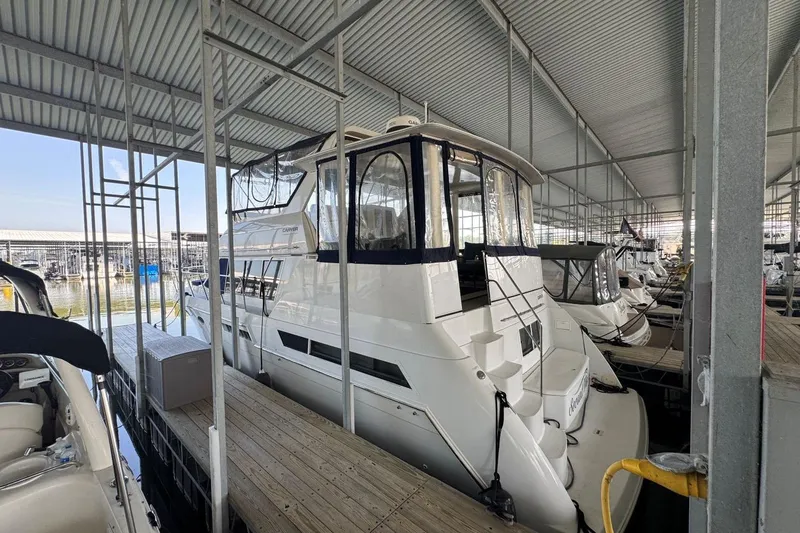 Slide: The Image of 1998 Carver 405 Motor Yacht docked in a covered marina. - 7
