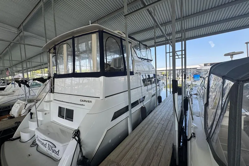 Slide: The Image of 1998 Carver 405 Motor Yacht docked in a covered marina, side view. - 8