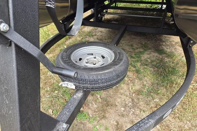 Slide: The Image of 2026 Sun Tracker BB 16 XLS trailer with spare tire mounted underneath. - 10