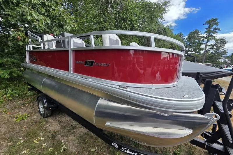 Slide: The Image of 2026 Sun Tracker BB 16 XLS pontoon boat with red exterior, parked on a trailer. - 5