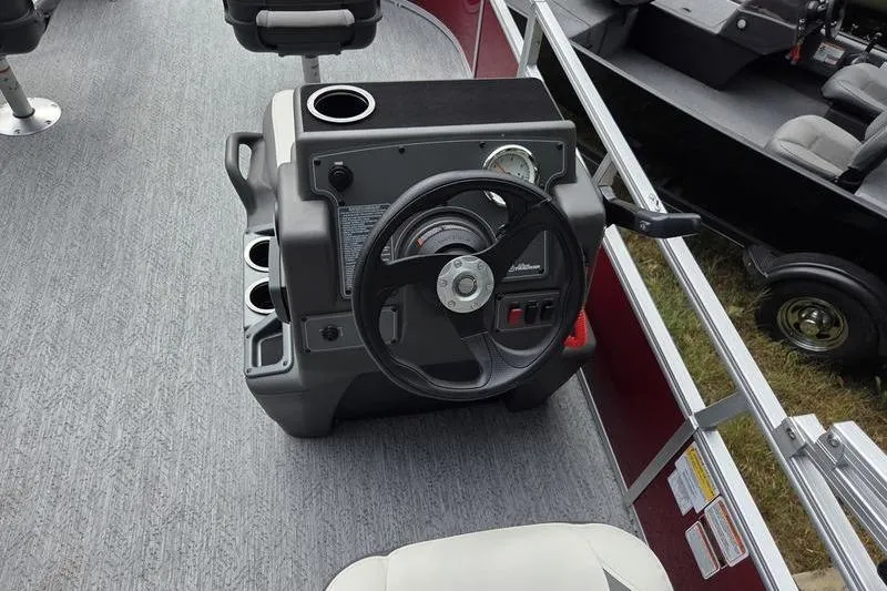 Slide: The Image of Steering console of 2026 Sun Tracker BB 16 XLS pontoon boat with cup holders. - 9