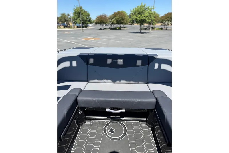 Slide: The Image of 2025 MasterCraft NXT22 boat interior with gray seating and hexagonal floor design. - 12