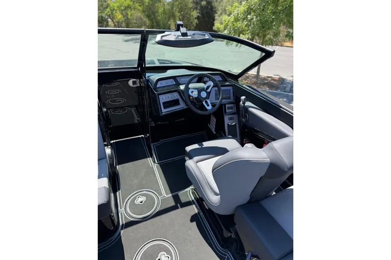 Slide: The Image of 2025 MasterCraft NXT22 boat interior with modern dashboard and steering wheel. - 18