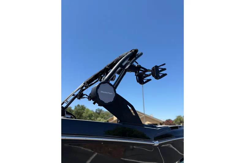 Slide: The Image of 2025 MasterCraft NXT22 boat tower against clear blue sky. - 8