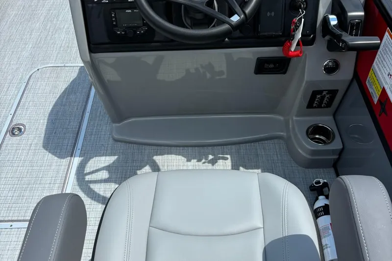 Slide: The Image of 2026 Berkshire 24RFX CTS boat interior with steering wheel, seat, and control panel. - 10